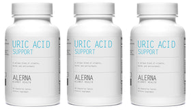 Alerna Complément Uric Acid 60 Comprimés Végétariens avec une main tenant le flacon