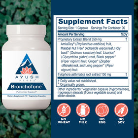 Ayush Herbs Bronchotone capsules sur une surface en bois