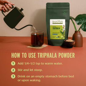 Banyan Botanicals Poudre de Triphala Bio 472g mélangée dans un verre