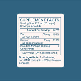 BodyBio Zinc Liquide 82g sur une table avec un verre