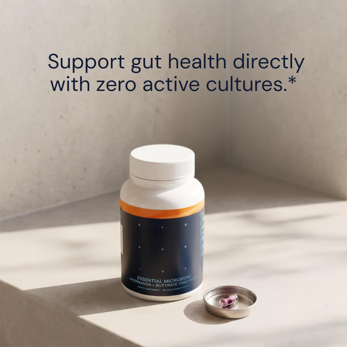 Bouteille de capsules microbiome essentielles Blueprint Bryan Johnson ouverte
