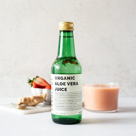 Bouteille de jus d'aloe vera Erbology sur une table en bois