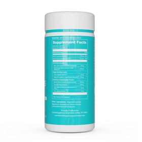 Bouteille de UpNourish avec capsules et fruits en arrière-plan