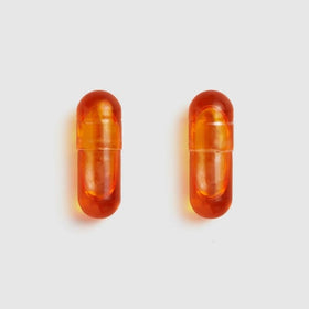 Bouteille Juice Plus+ Omega Blend ouverte avec capsules visibles