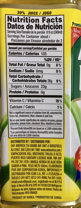 Bouteilles d'OKF Aloe Vera King sur une surface en bois
