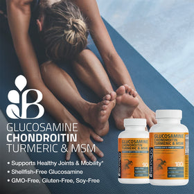 Bronson Glucosamine Chondroitin Turmeric & MSM capsules on a wooden table