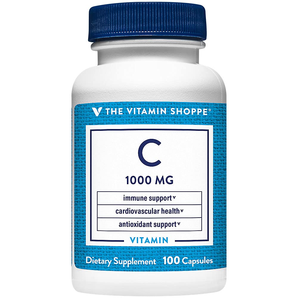 Capsules de C-1000 de The Vitamin Shoppe sur une cuillère en bois