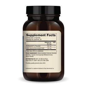 Capsules de Dr. Mercola L-Theanine Plus GABA sur une surface blanche