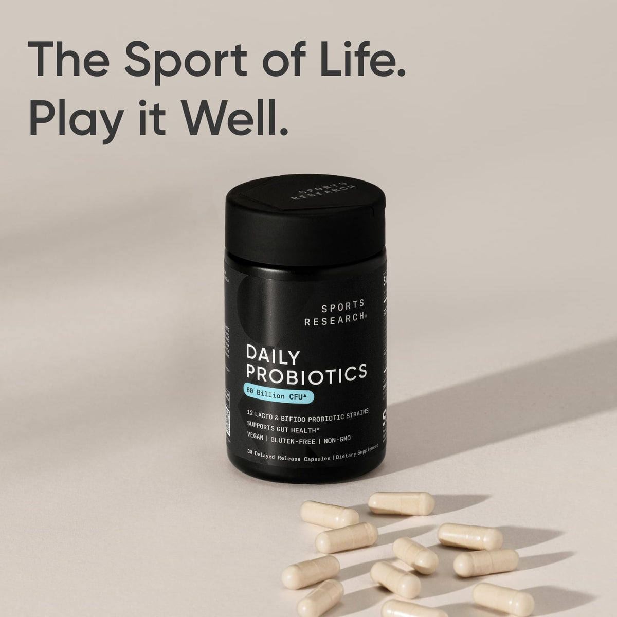 Capsules de Probiotiques Quotidiens Sports Research à côté d'un verre d'eau