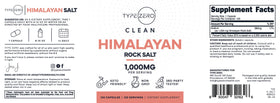Capsules de sel de mer himalayen Type Zero à côté d'un verre d'eau