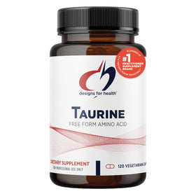 Capsules de taurine Designs for Health sur une surface en bois