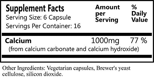 Capsules végétariennes de Daily Manufacturing Cal-II™ sur une table
