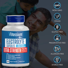 Capsules Vitassium de sodium et potassium à côté d'un verre d'eau