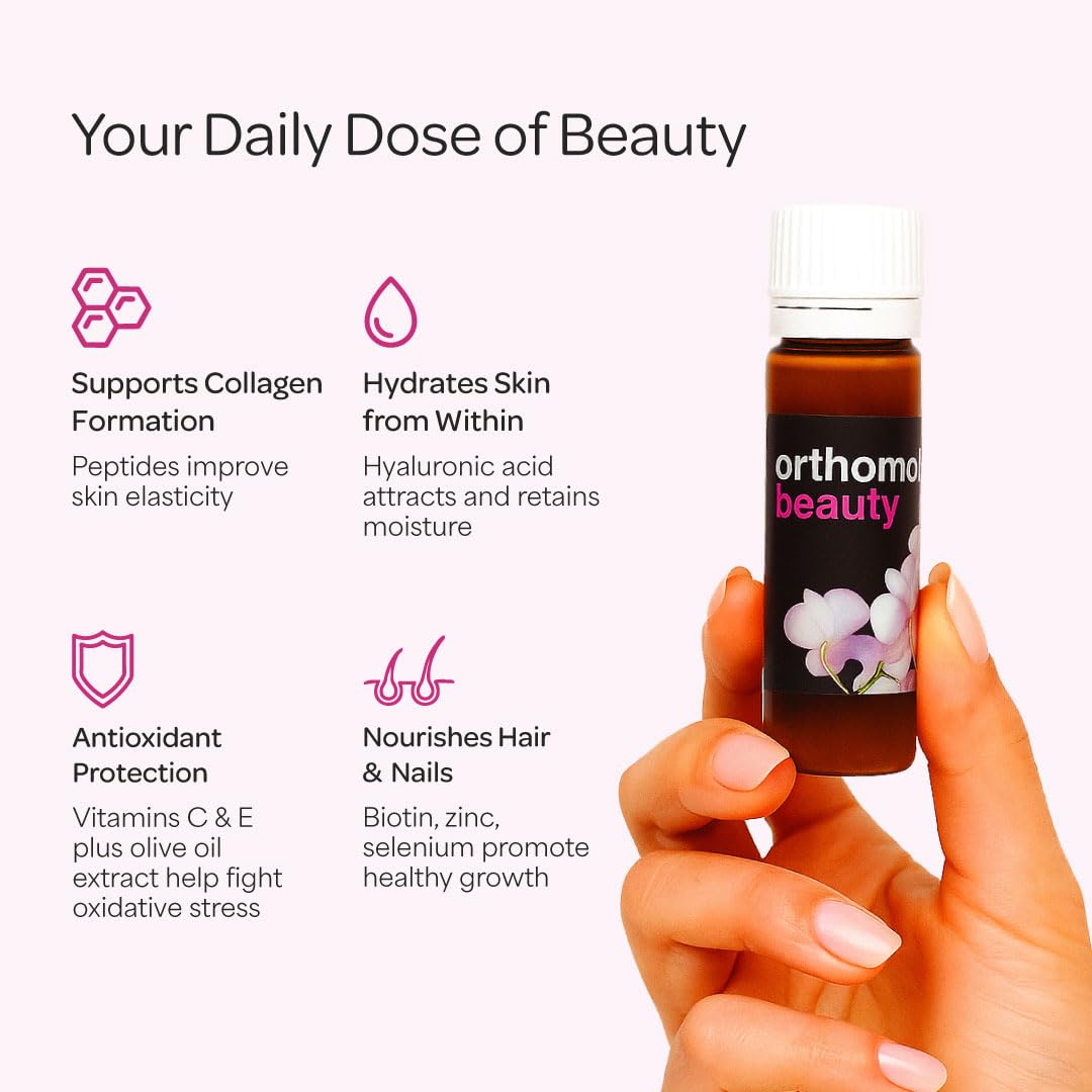 Complément Orthomol Beauté sur une table avec des fleurs