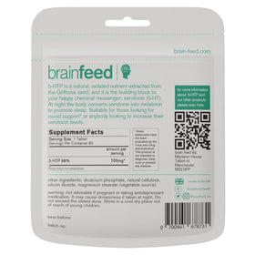 Comprimés 5-HTP brain feed à côté d'une tasse d'eau