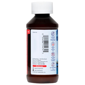 De La Cruz Huile de Foie de Morue Pure 4 oz à côté d'une assiette