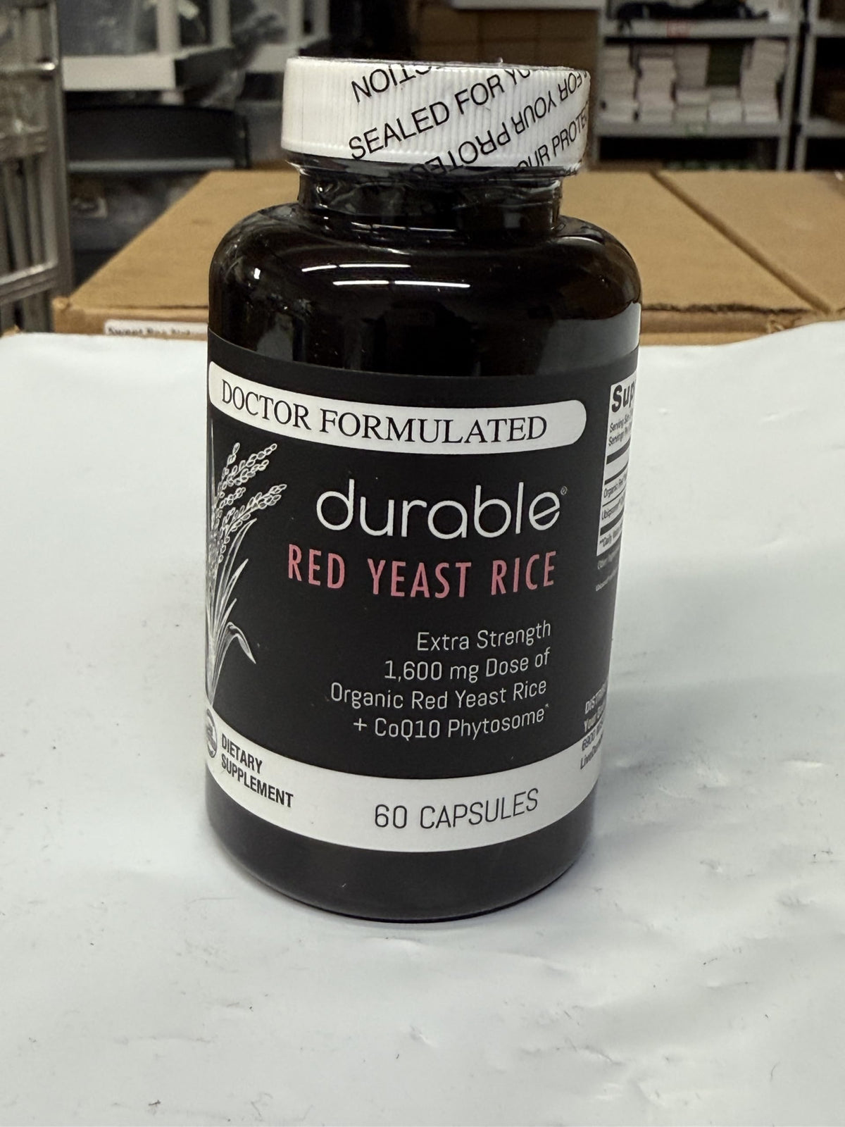 Durable Riz Rouge 1 600 mg avec CoQ10, prise de comprimés avec un verre d'eau