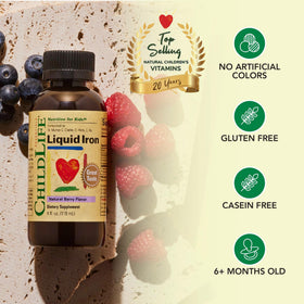 Fer Liquide CHILDLIFE ESSENTIALS sur une table avec des baies