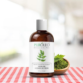Flacon d'huile de Neem PURÓLEO avec une plante en arrière-plan