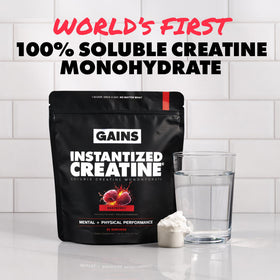 GAINS IN BULK Créatine Monohydrate Instantanée Framboise à côté d'un shaker