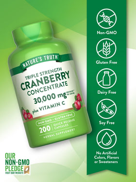 Gélules de canneberge et vitamine C dans une cuillère
