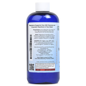 Good State magnésium ionique 16 oz bouteille à côté d'un verre d'eau