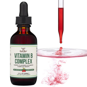 Gouttes de vitamine B-Complex Double Wood sur une table avec un verre d'eau