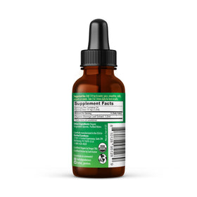 Gouttes liquides de Moringa Herbal Papaya versées dans un verre d'eau