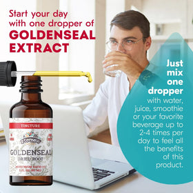Gouttes liquides de teinture de Goldenseal sur une surface en bois
