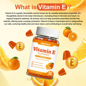 Gummies de vitamine E Agumoon à côté d'un verre d'eau