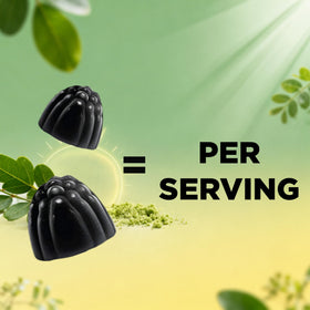 Gummies Vitamatic Moringa 200 mg à côté d'un verre d'eau