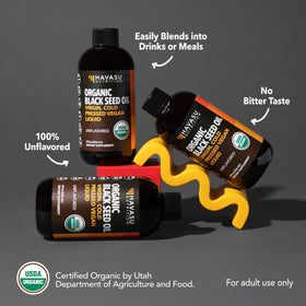 Huile de nigelle bio HAVASU NUTRITION sur une table en bois