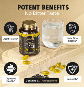 Maju Superfoods capsules d'huile de graines noires sur une surface en bois
