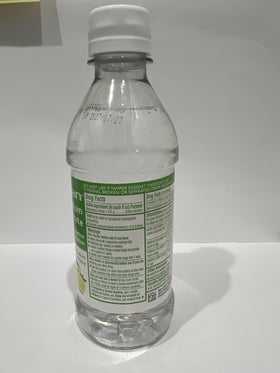 MedRite Solution de Citrate de Magnésium 349g près d'une bouteille d'eau
