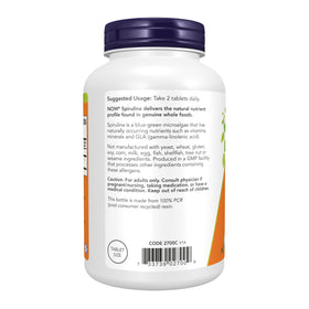 NOW Foods Spiruline Bio 500 mg comprimés dans une main