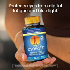 Nutrex Hawaii EyeAstin comprimés sur une surface blanche