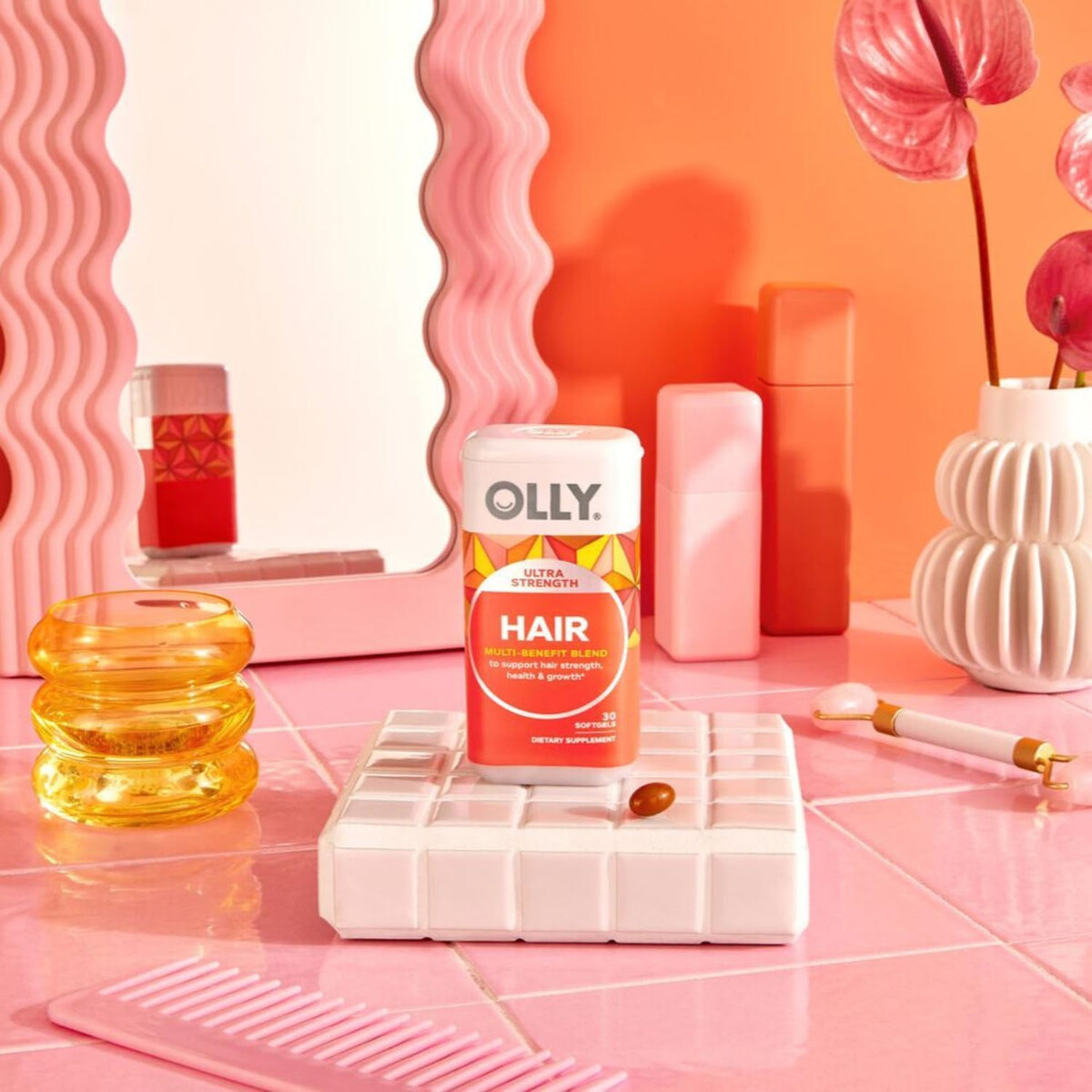 OLLY Cheveux Ultra Force sur une table avec des ingrédients naturels