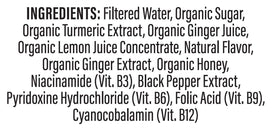 Personne tenant un shot de curcuma Turmeric Time