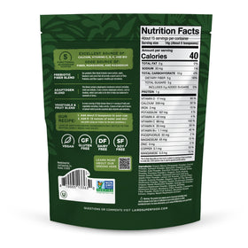 Poudre de greens prébiotiques Laird Superfood 227g avec cuillère et verre d'eau