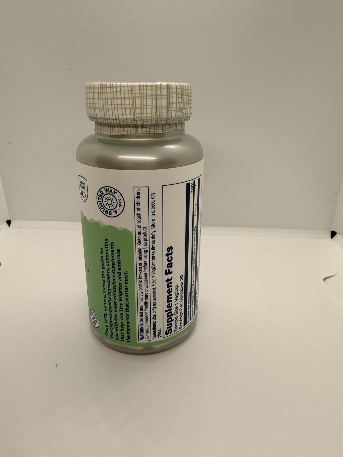 SOLARAY DAO Enzyme 60000 HDU 30 VegCaps à côté d'un verre d'eau