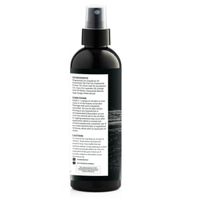 Spray d'huile de magnésium Aromasong sur une table avec des accessoires