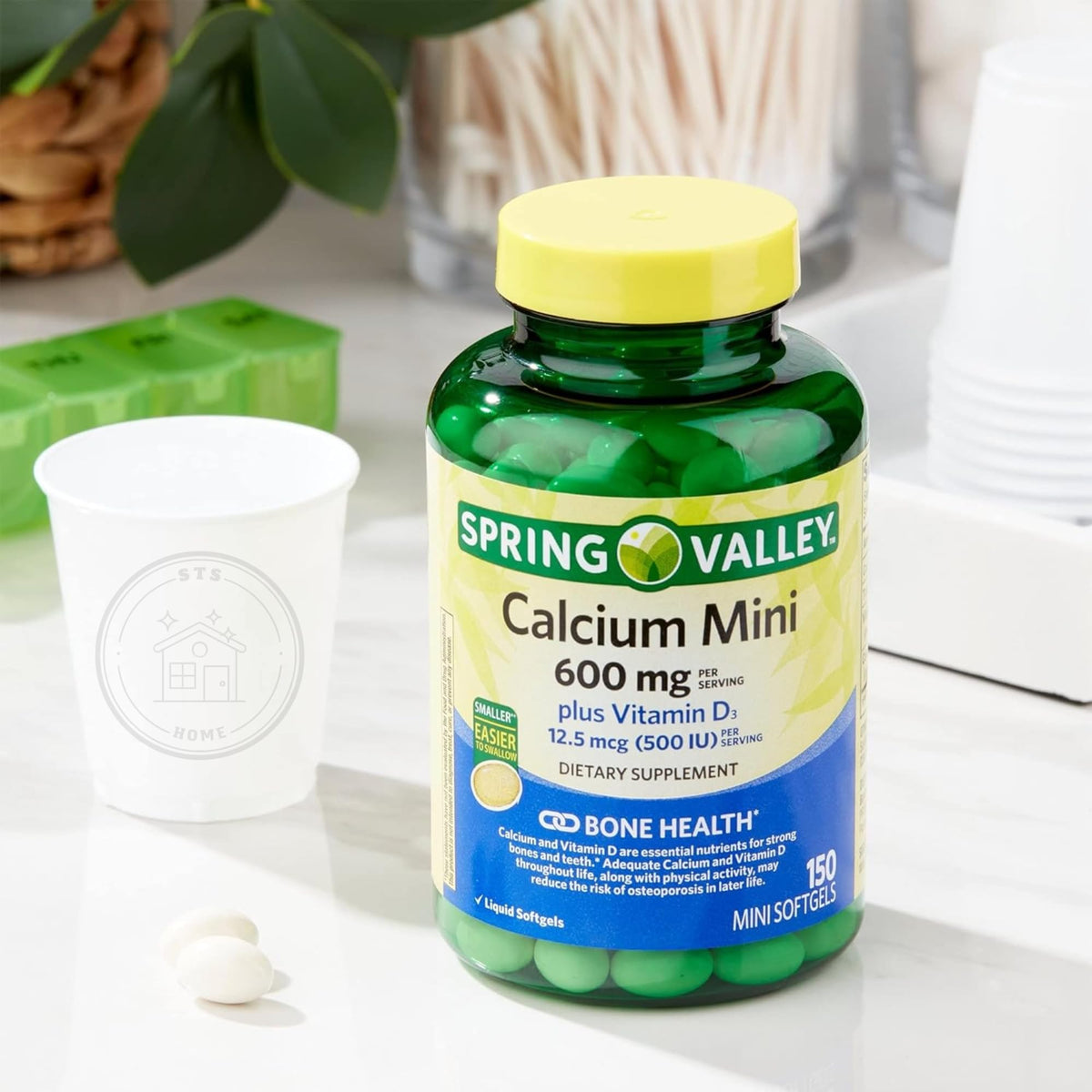 STS Home Calcium Plus Vitamine D3 150 Mini Softgels, comparatif de taille avec une pièce