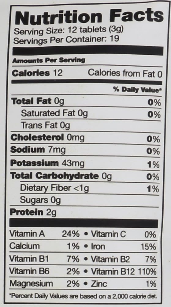 Sunfood Superfoods Chlorella and Spirulina tablets in hand