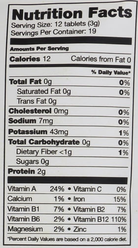 Sunfood Superfoods Chlorella and Spirulina tablets in hand