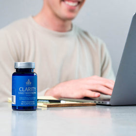 Thrivous Clarity bottle with a glass of water