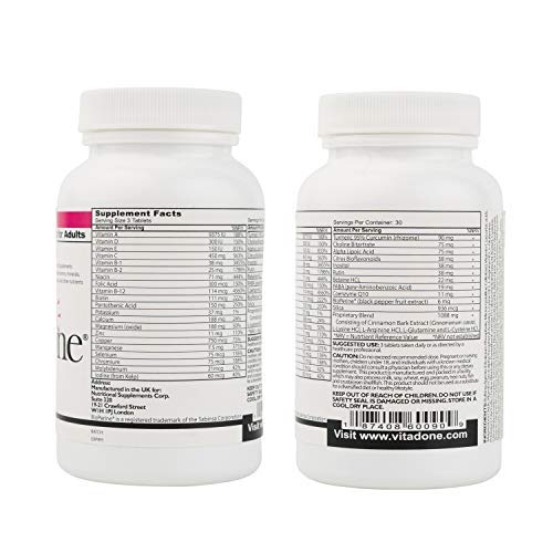 Vitadone multivitamines sur une table avec d'autres suppléments
