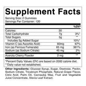 Vitamatic Gummies au fer 65 mg à côté d'un verre d'eau