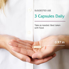 Vitanica Opti-use capsules à côté d'un verre d'eau