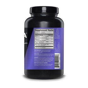 ZMA JYM Zinc & Magnésium sur une table avec un verre d'eau